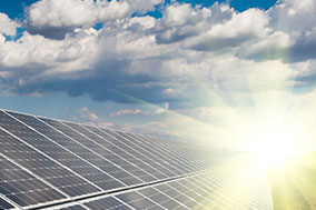 sun rise and clouds over solar panel field