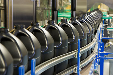 large black plastic jugs on manufacturing conveyor belt
