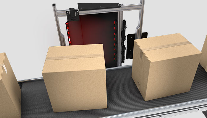 Boxes being scanned by side-mounted barcode reading system