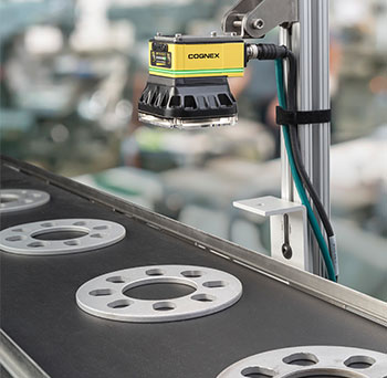 Cognex in-sight 2000 mounted above metal discs on conveyor for default inspection
